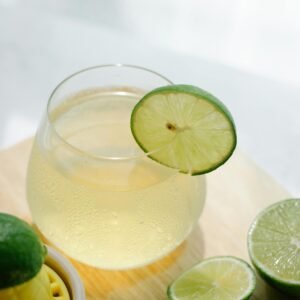 Refreshing lime drink in a glass with fresh lime slices, perfect for a summer day.